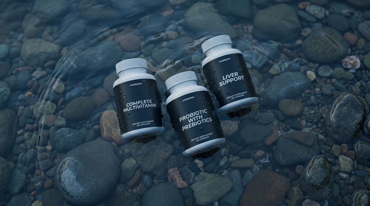 Acendsion multivitamin, probiotic and liver support containers on wet river stones