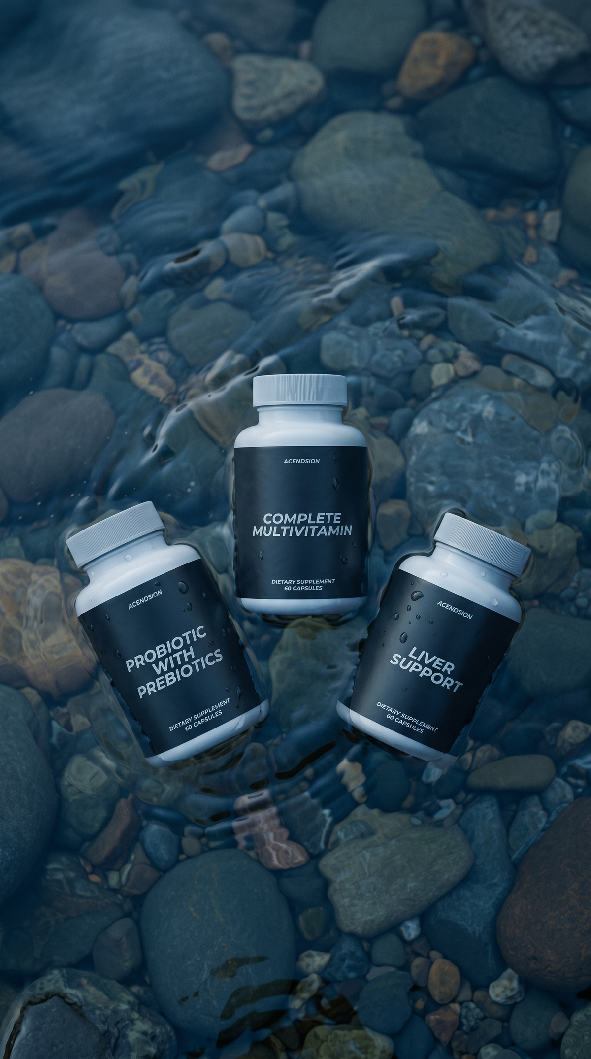 Acendsion multivitamin, probiotic and liver support containers on wet river stones